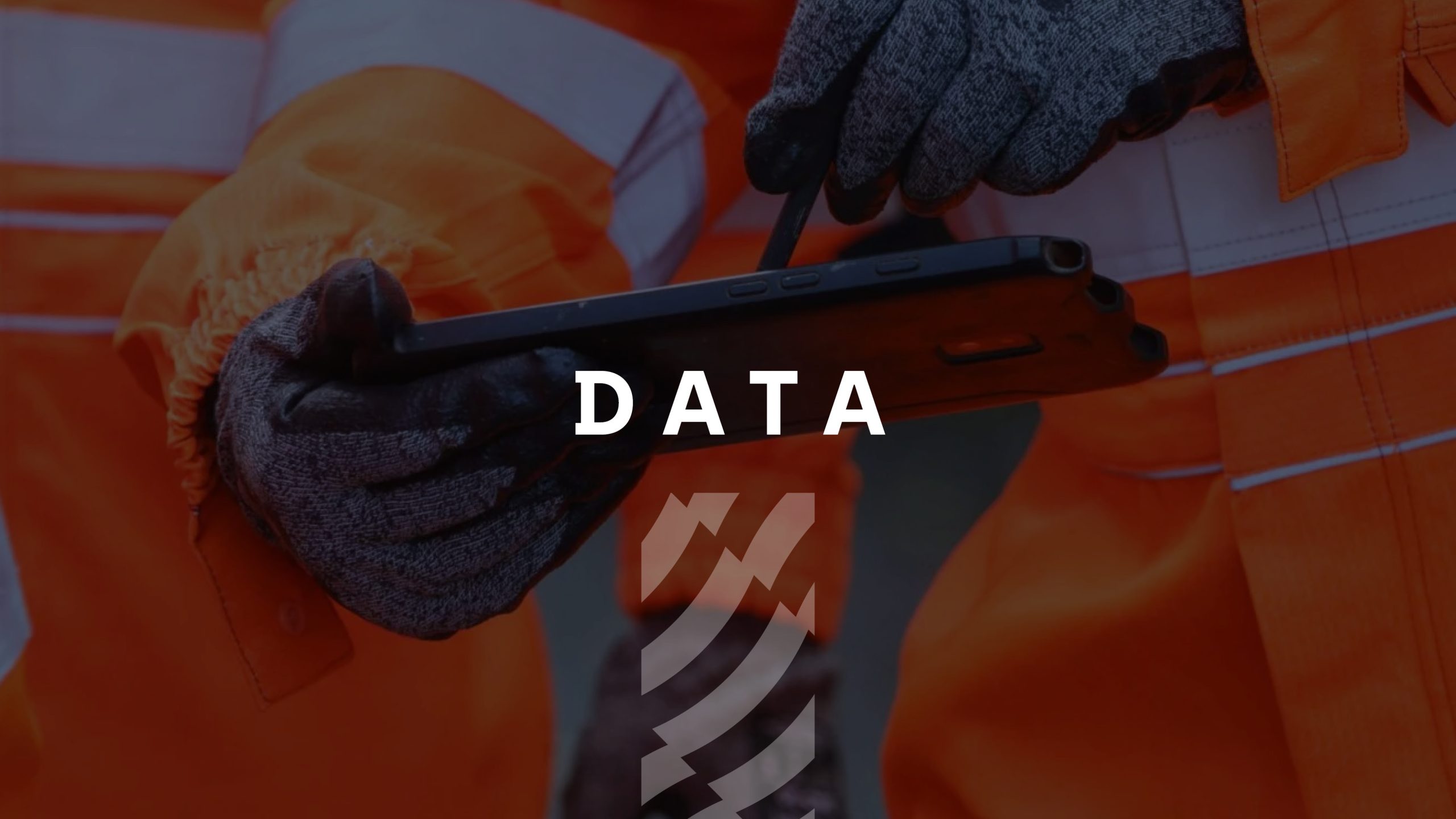 Browne Group - Two people in orange work uniforms use a tablet; the word 